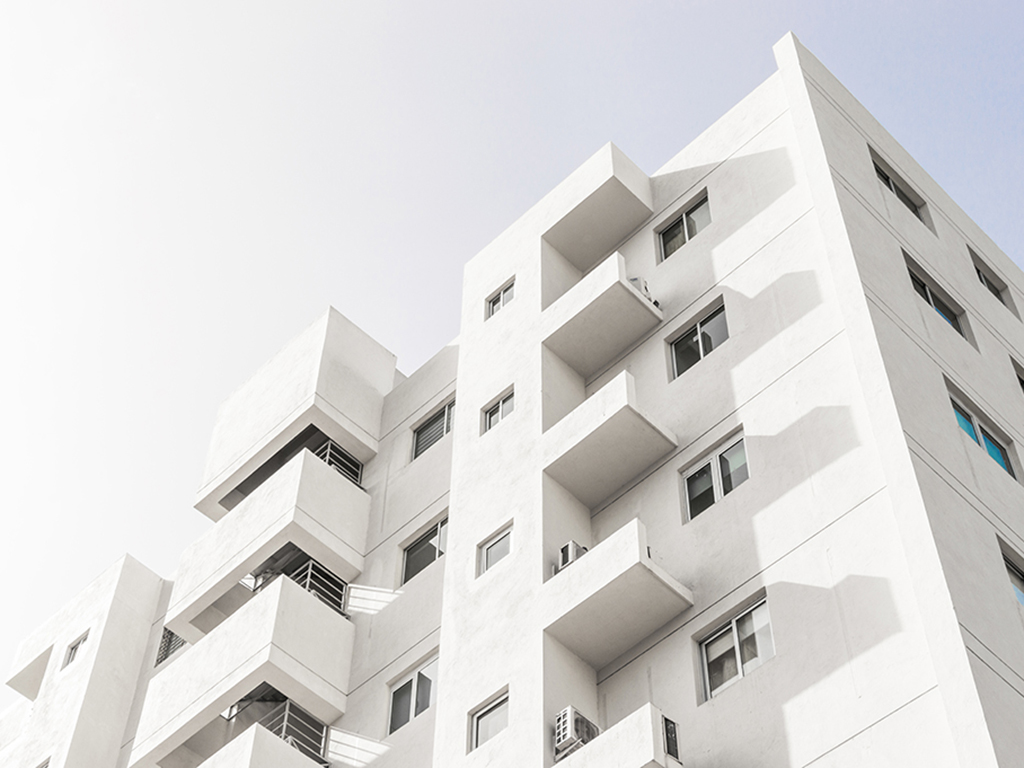 low-angle-shot-facade-white-modern-building-blue-clear-sky